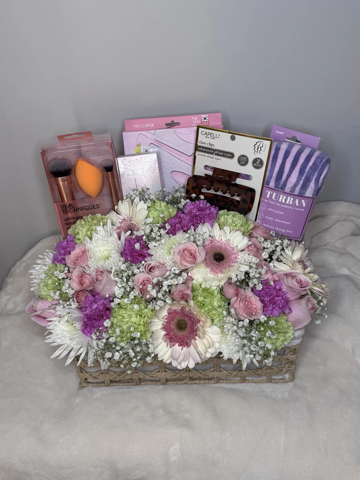 Self-care products and lavender flowers arranged together in a gift basket