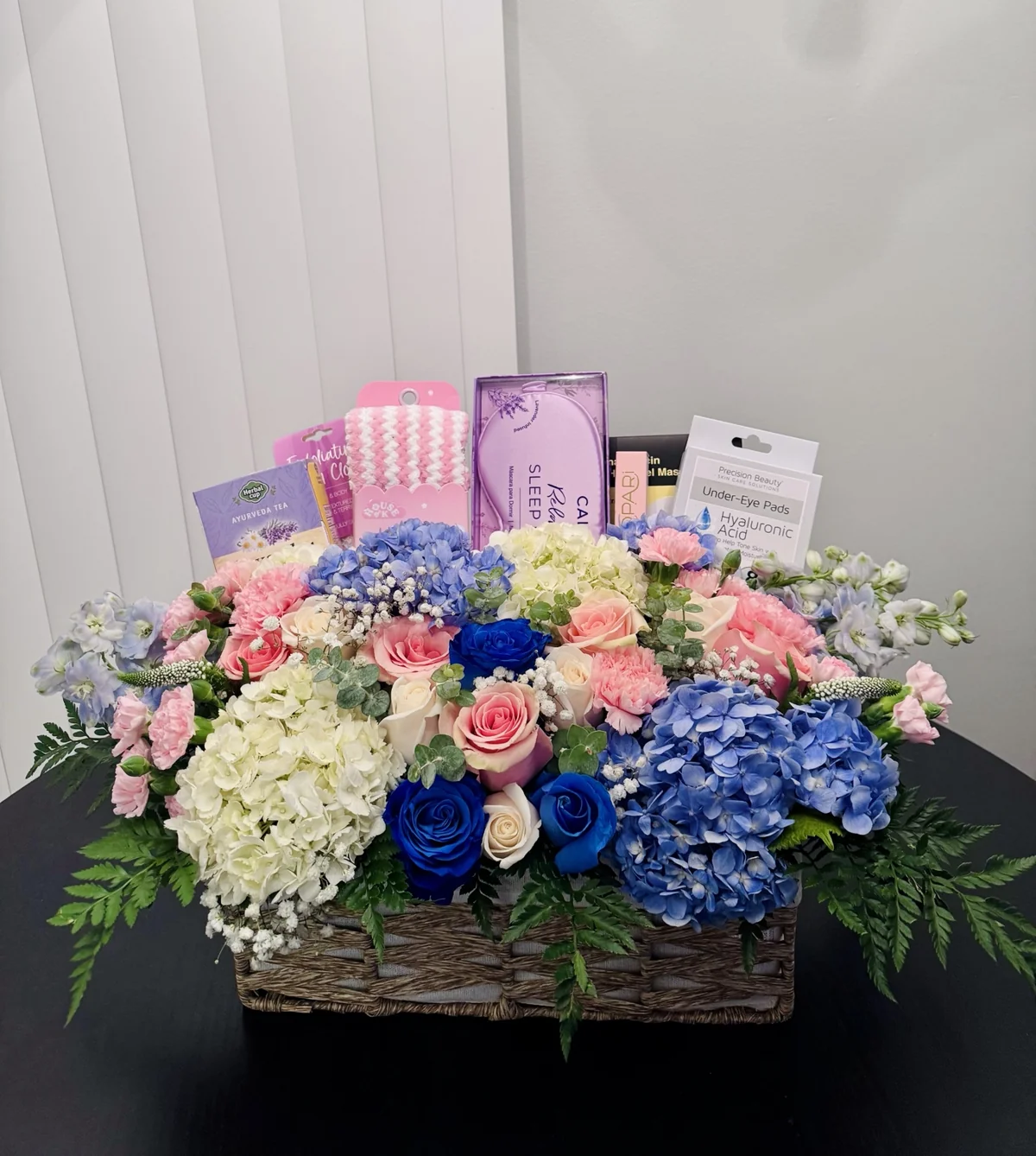 Pastel flower basket with thoughtfully selected gift items