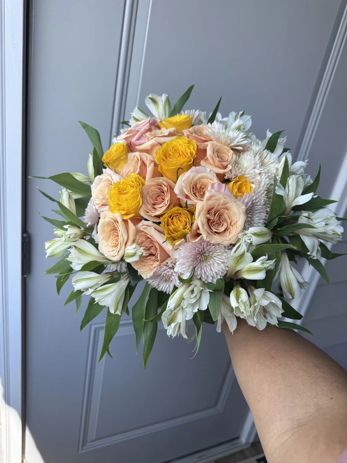 Yellow roses and white flowers in a lush signature bouquet